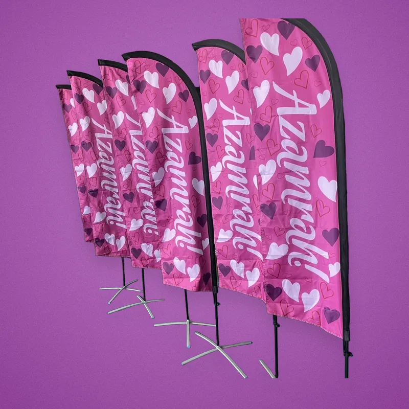 Row of pink feather flags printed with hearts and 'Azamrah!'